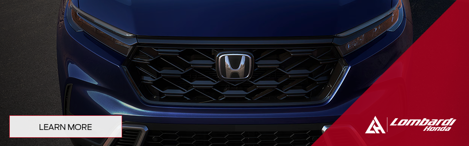 Close-up of the front grille of the blue 2026 Honda CR-V, with Lombardi Honda branding.