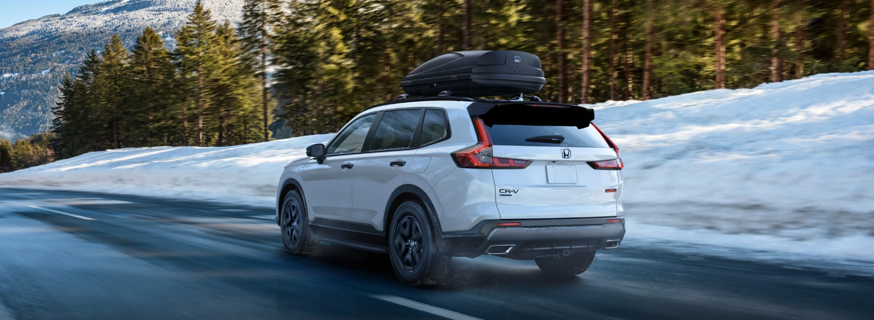 2026 Honda CR-V Hybrid driving on a snowy road in the Laurentians.