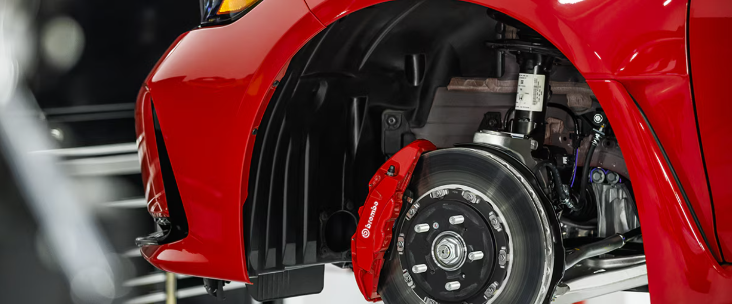 Close-up of high-performance Brembo brake system during spring maintenance service